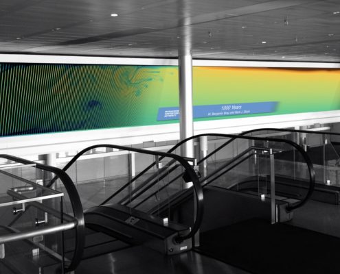 A long screen showing colorful ocean circulation currents, mostly blues, greens and yellows, at the Boston Convention and Exhibition Center