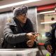 A student holds a crab and laughs while showing a second girl during the High School Marine Science Symposium at Northeastern University