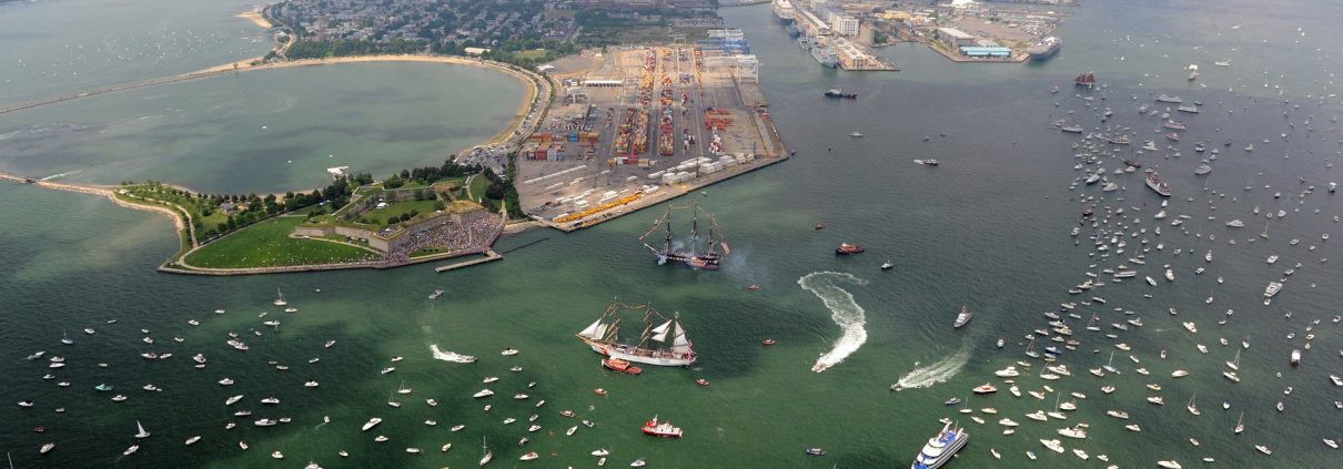 Aerial photograph of Castle Island and Massachusetts Bay with many boats and tall ships