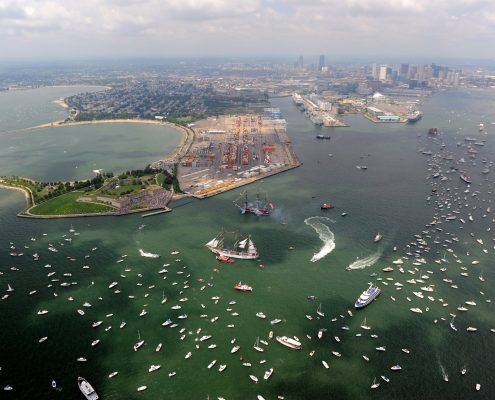 Aerial photograph of Castle Island and Massachusetts Bay with many boats and tall ships