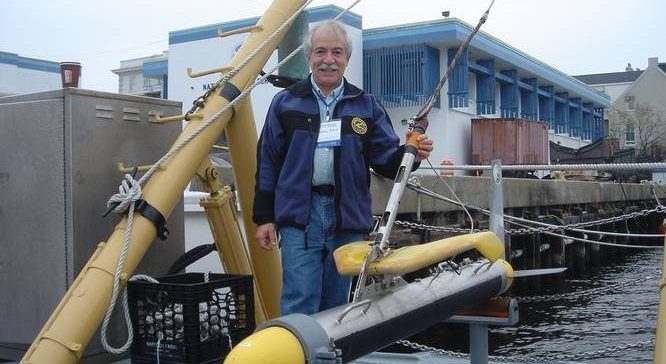 Marty Klein on a dock with a submersible piece of underwater engineering equipment