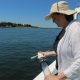 Dr. Juliet Simpson holds sediment core on a boat in Massachusetts.