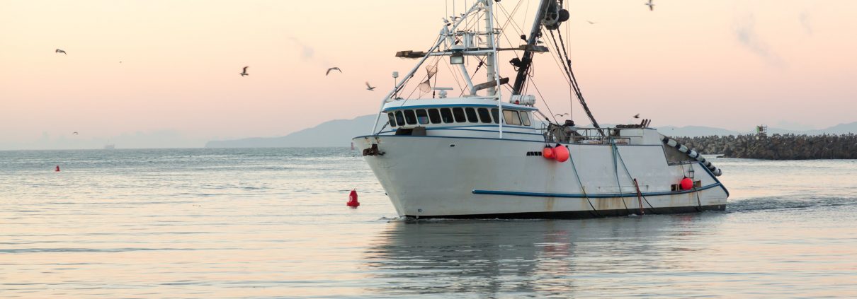 Fishing boat on the water at sunrise