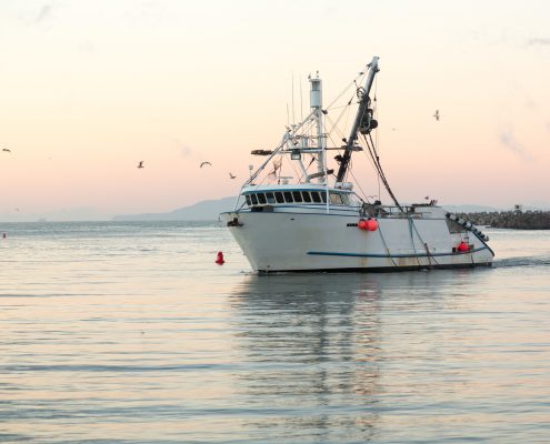 Fishing boat on the water at sunrise