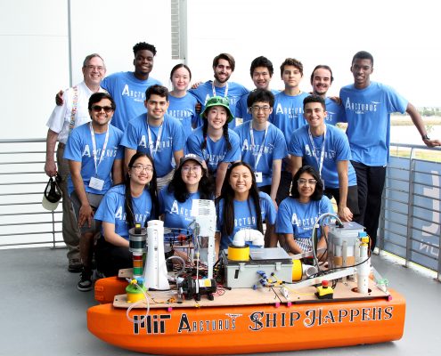 MIT Arcturus Team with MIT Sea Grant Education Administrator Drew Bennett and their autonomous vessel at the 2023 RoboBoat Competition