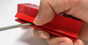 Prying apart the mold pieces using a flat blade screwdriver