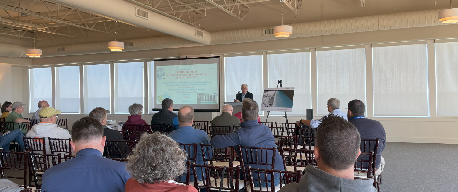 MIT Sea Grant Director Michael Triantafyllou speaking to a room of people.