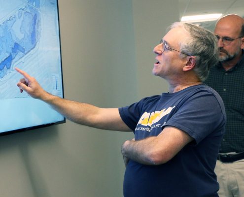 Michael Sacarny pointing to the Charles River map